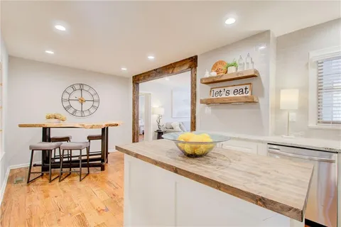 a view of a dining room with furniture and a window