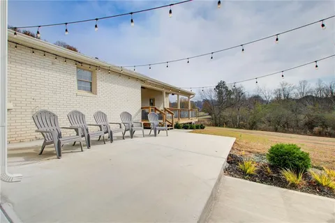 a view of a patio with a table and chairs under an umbrella
