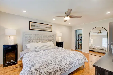 a bedroom with a large bed and a fireplace