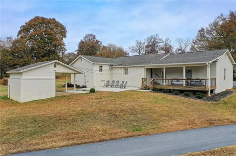 a view of a house with pool and a yard