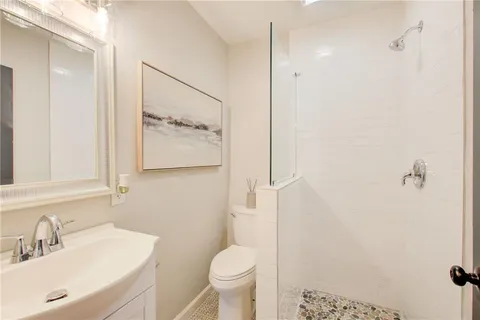 a bathroom with a sink toilet and shower