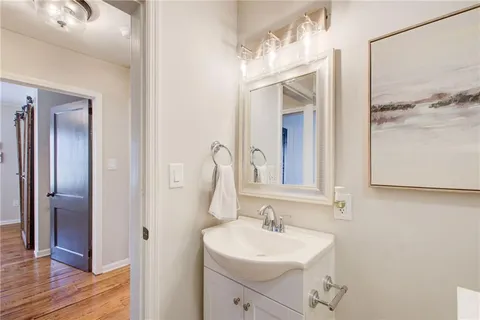 a bathroom with a sink a mirror and a shower