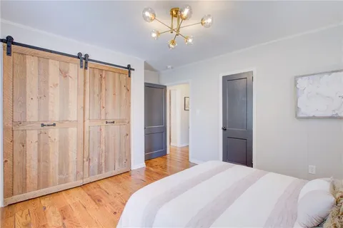 a bedroom with a bed and a chandelier