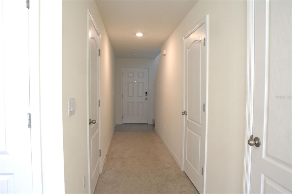 4079 Malawi Trail St. Cloud, FL 34772 - Photo 5 of 19 a view of a hallway with wooden floor