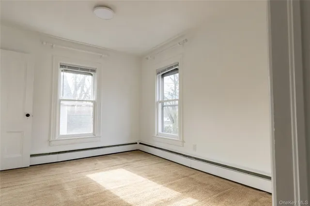 a bathroom with a toilet a sink and a window