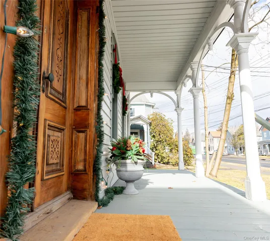 a view of porch with a table and chairs and potted plants