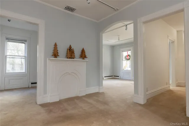 an empty room with window and ceiling fan