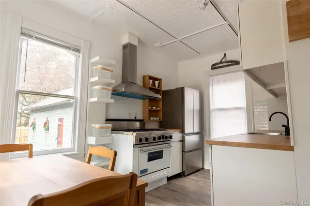 a kitchen with stainless steel appliances a stove a sink and a refrigerator