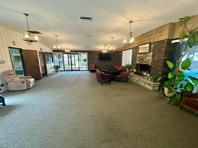 a living room with furniture a window and a flat screen tv