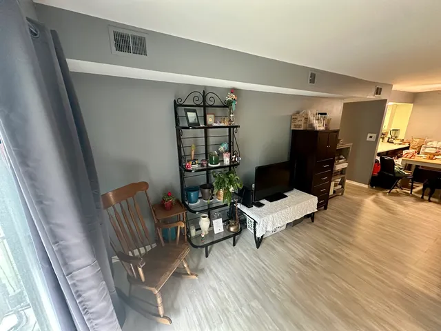 a living room with furniture window and wooden floor