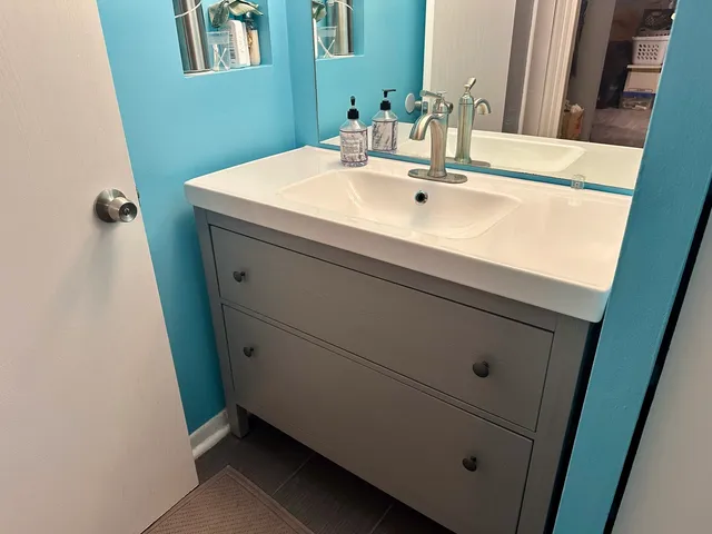 a bathroom with a sink and a mirror