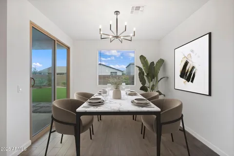 a view of a dining room with furniture wooden floor and chandelier