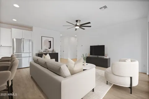 a living room with furniture a couch and a flat screen tv