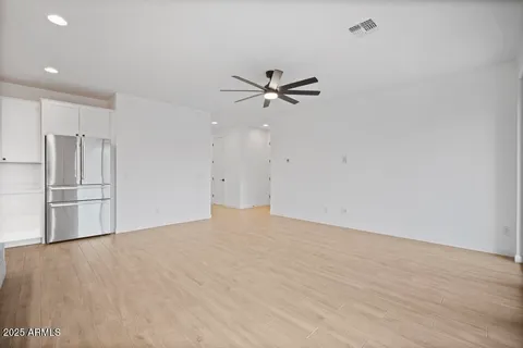 a view of an empty room with a ceiling fan