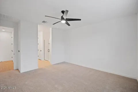 a view of a room with a ceiling fan