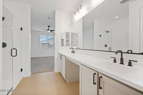 a bathroom with a sink double vanity and a mirror