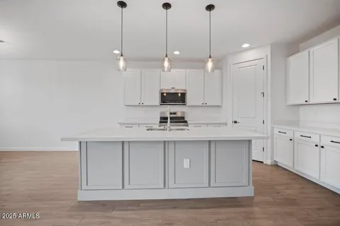 a view of a kitchen with electric appliances