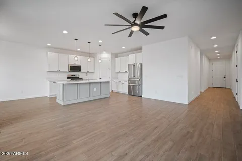a view of a kitchen with a sink and a refrigerator