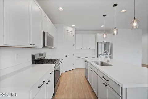 a kitchen with cabinets a sink and appliances