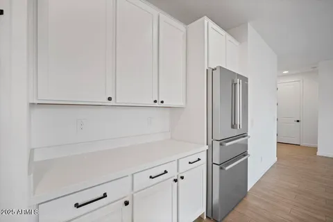 a kitchen with cabinets and a refrigerator
