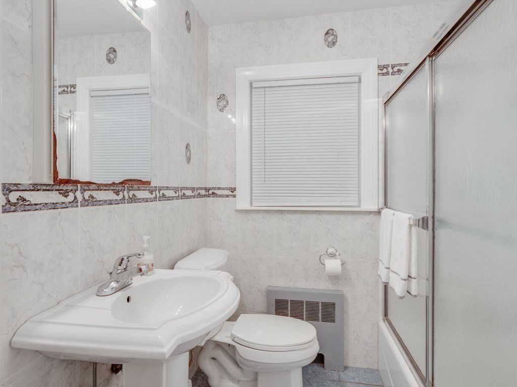 39 Echo Street Melrose, MA 02176 - Photo 12 of 32 a bathroom with a sink a toilet and mirror