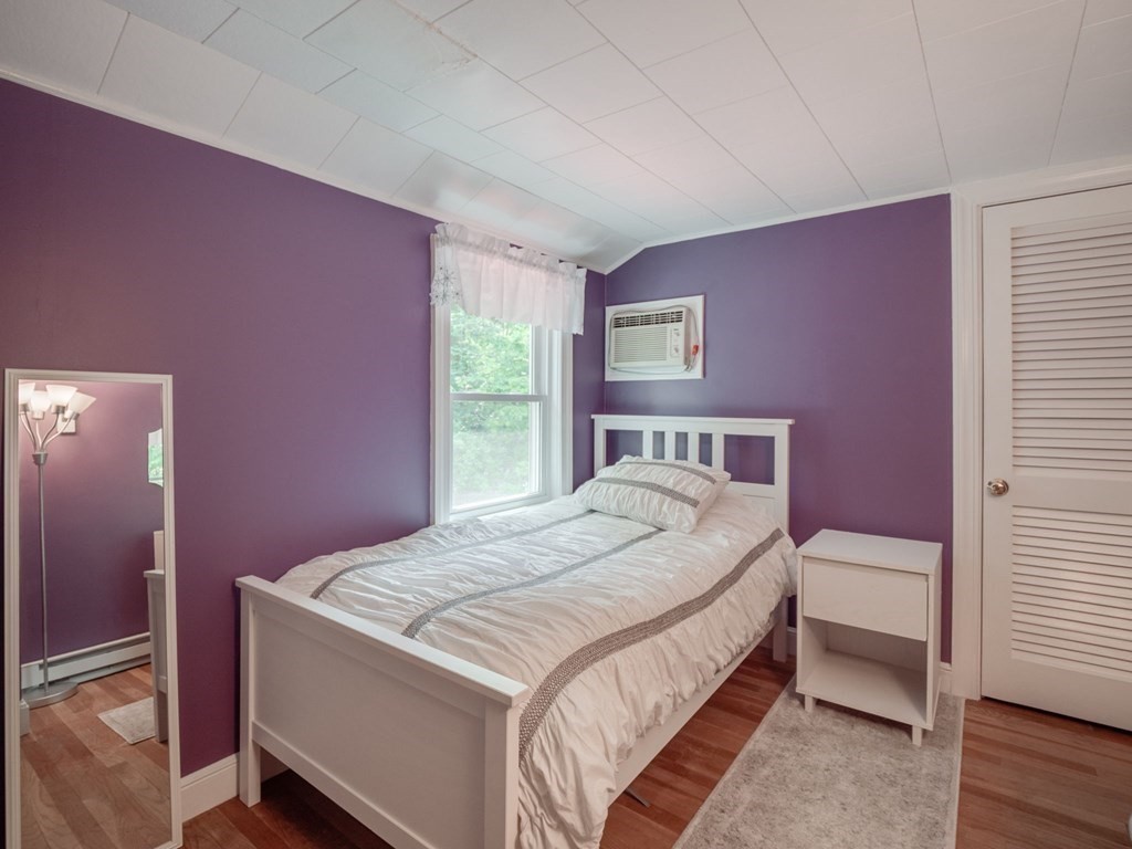 39 Echo Street Melrose, MA 02176 - Photo 18 of 32 a bed sitting in a bedroom next to a window