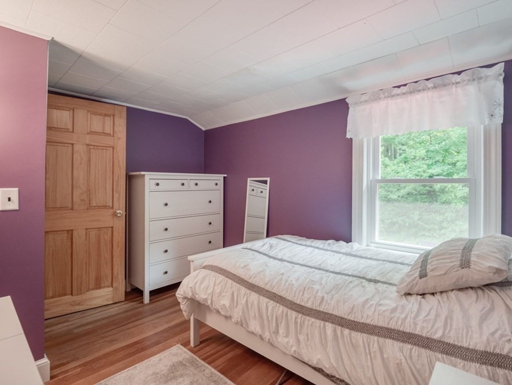 39 Echo Street Melrose, MA 02176 - Photo 19 of 32 a bedroom with a bed and a dresser