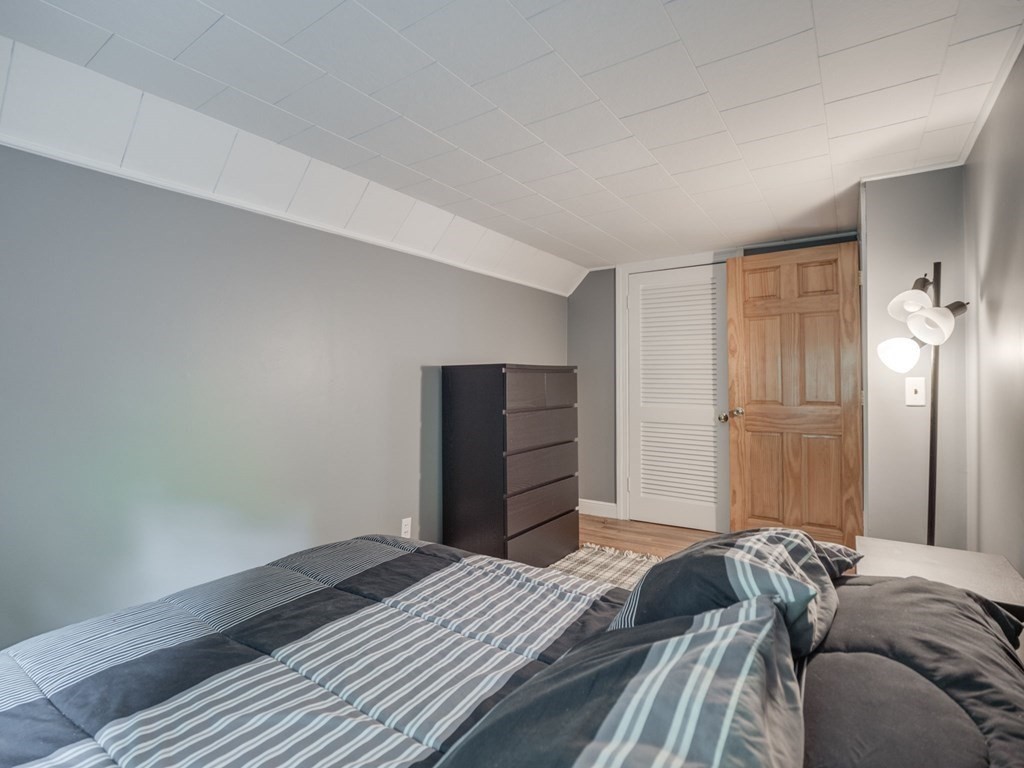 39 Echo Street Melrose, MA 02176 - Photo 21 of 32 a bedroom with a bed and wooden floor