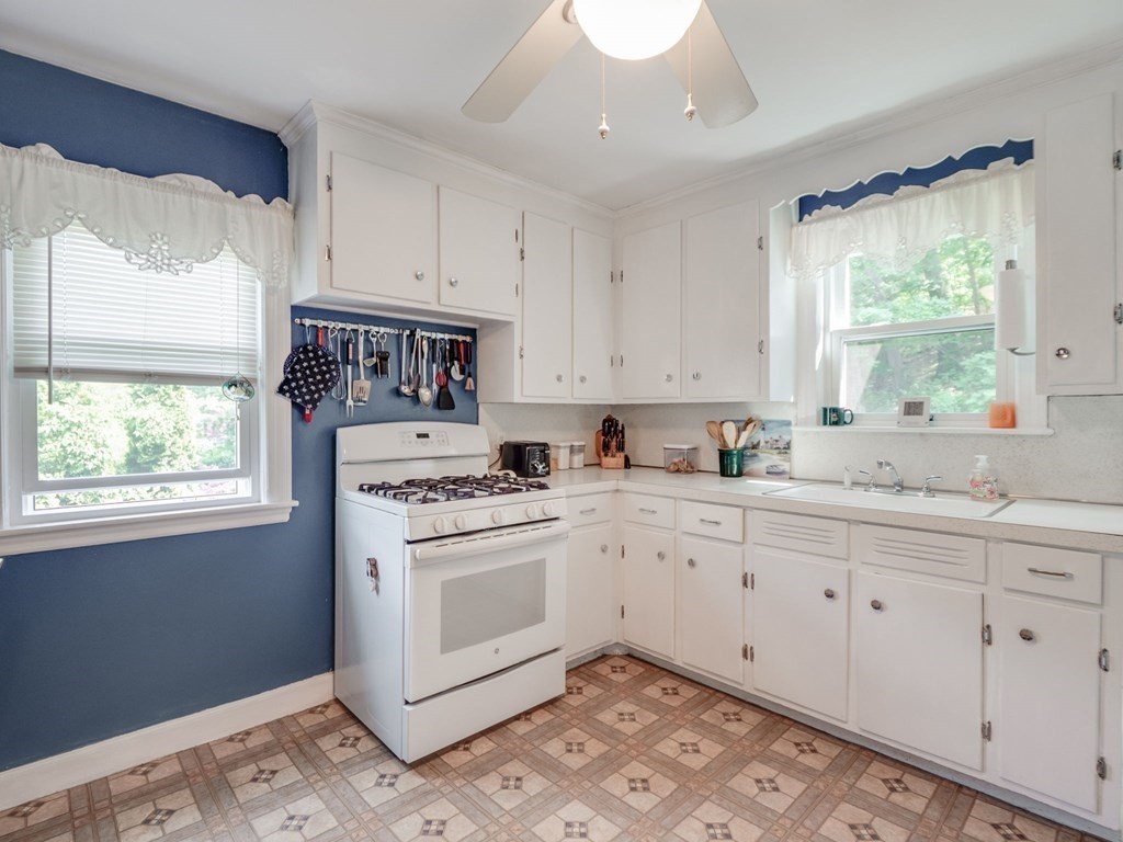 39 Echo Street Melrose, MA 02176 - Photo 6 of 32 a kitchen with granite countertop white cabinets and white appliances
