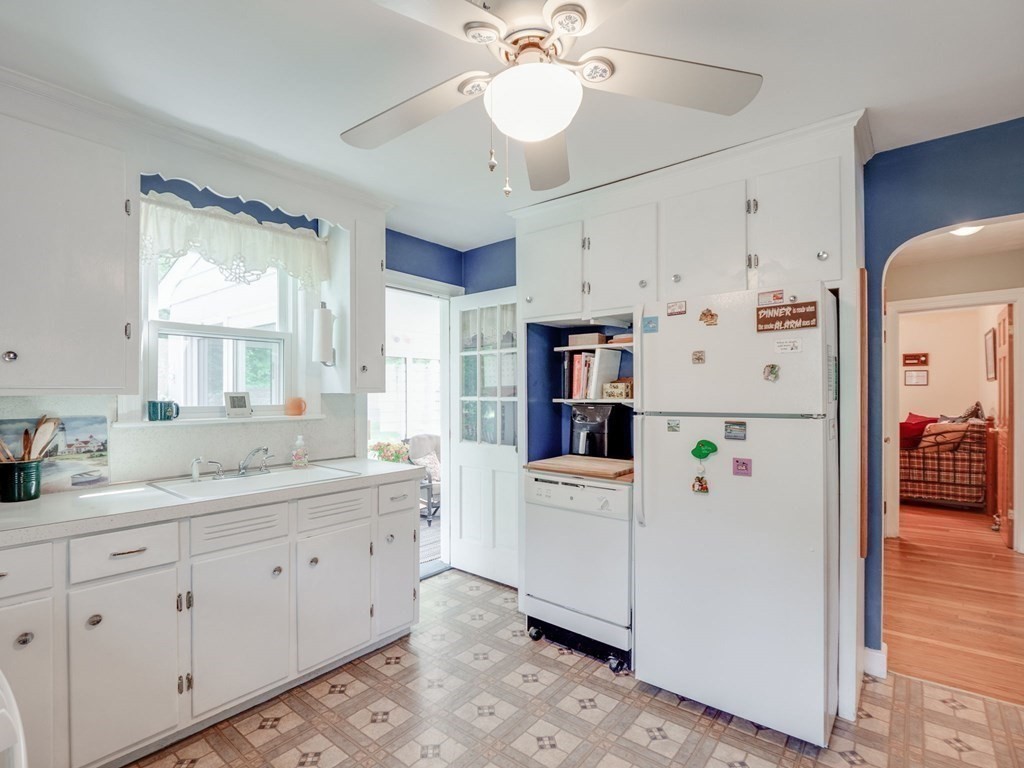 39 Echo Street Melrose, MA 02176 - Photo 7 of 32 a kitchen with white cabinets and white appliances