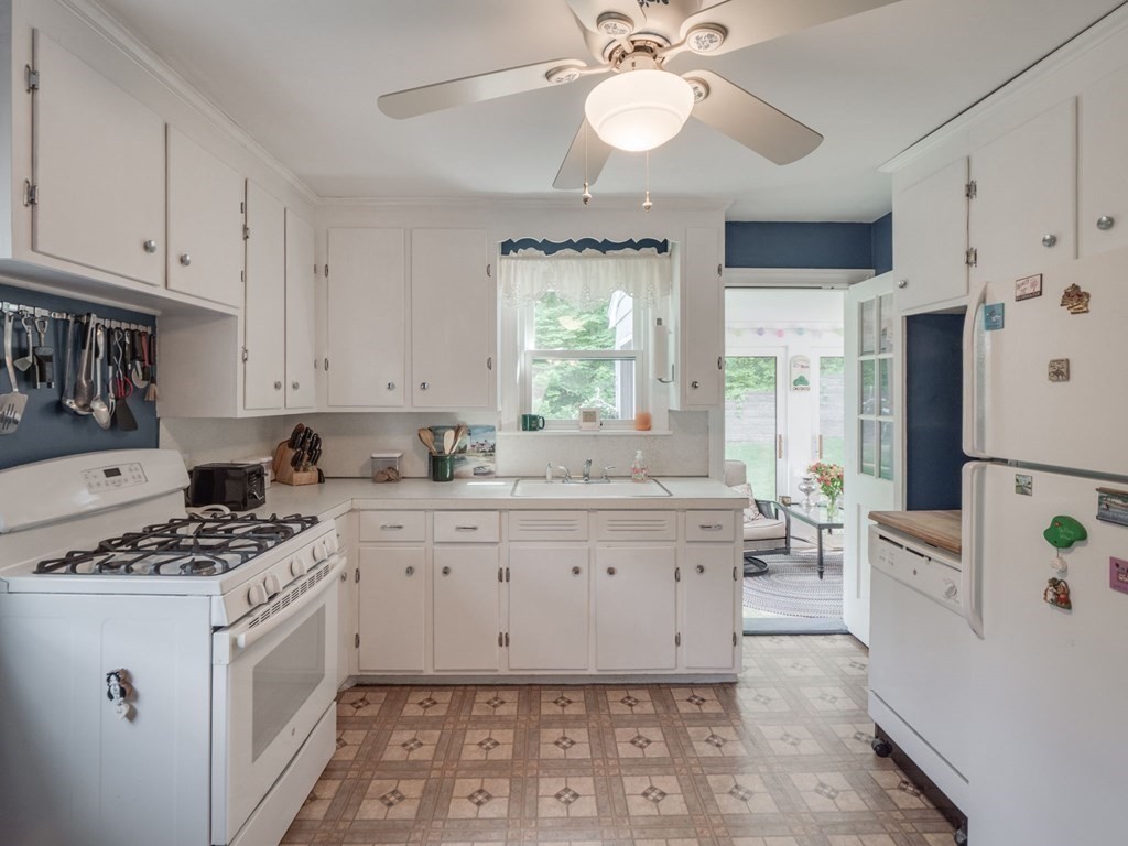 39 Echo Street Melrose, MA 02176 - Photo 9 of 32 a kitchen with stainless steel appliances a stove a sink cabinets and a window