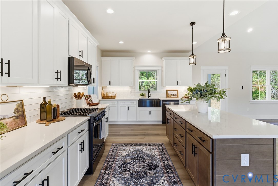 7376 River Road Hanover, VA 23069 - Photo 13 of 46 a kitchen with stainless steel appliances kitchen island granite countertop a sink stove and cabinets