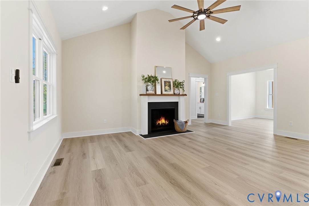7376 River Road Hanover, VA 23069 - Photo 17 of 46 a view of an empty room with wooden floor fireplace and a window