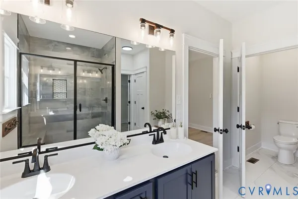 a bathroom with a sink a toilet and a mirror