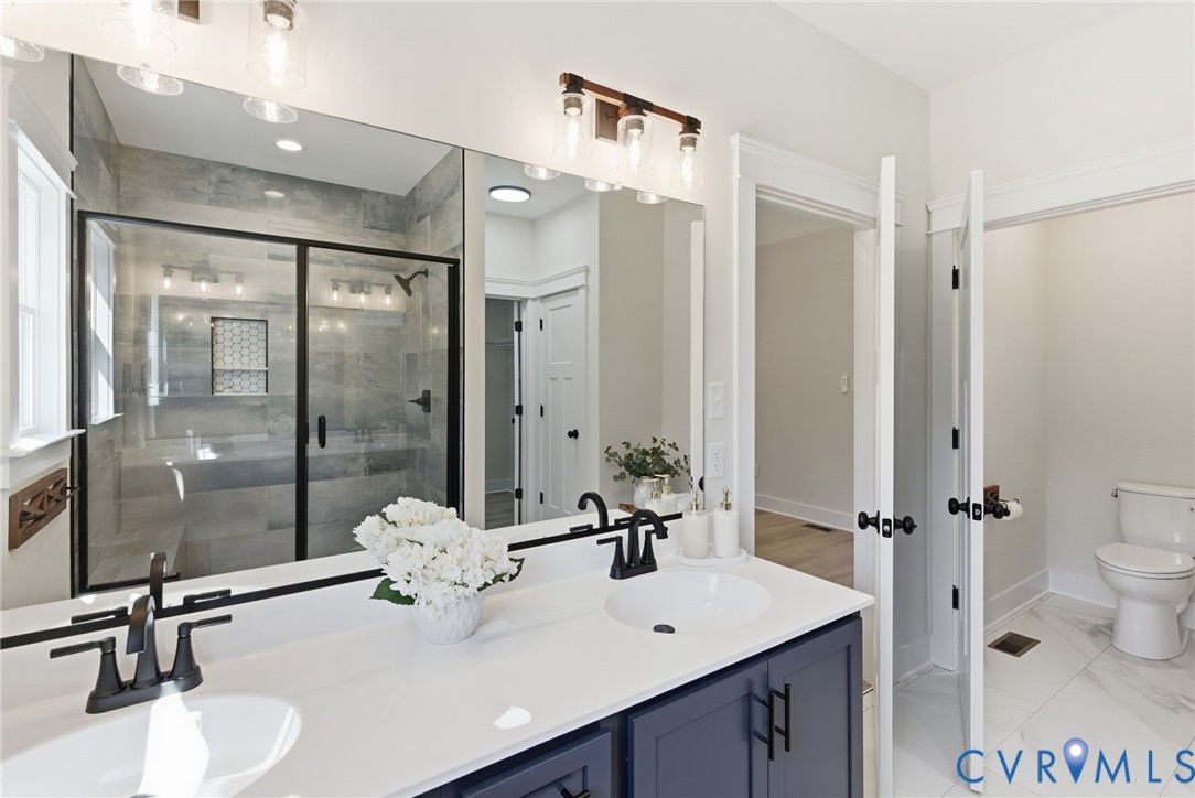 7376 River Road Hanover, VA 23069 - Photo 33 of 46 a bathroom with a sink a toilet and a mirror