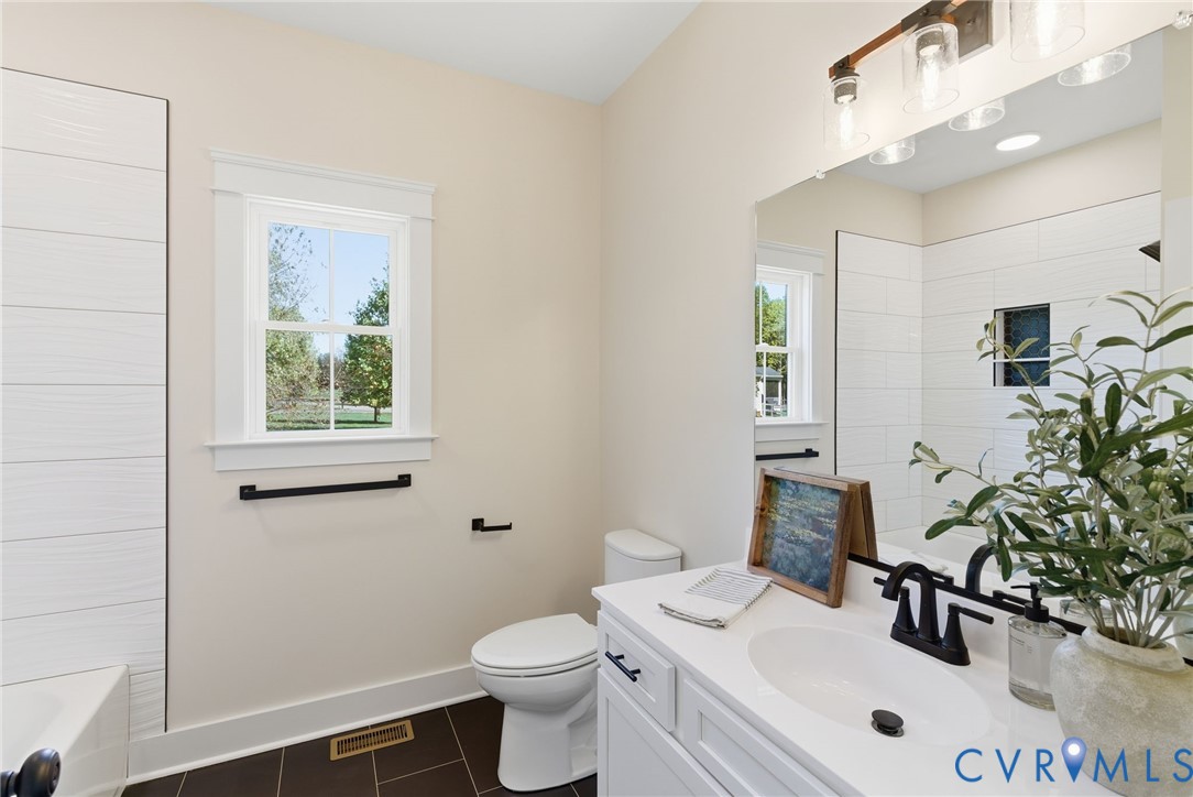 7376 River Road Hanover, VA 23069 - Photo 34 of 46 a bathroom with a sink mirror and toilet