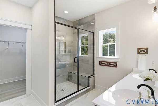 a bathroom with a shower and a sink
