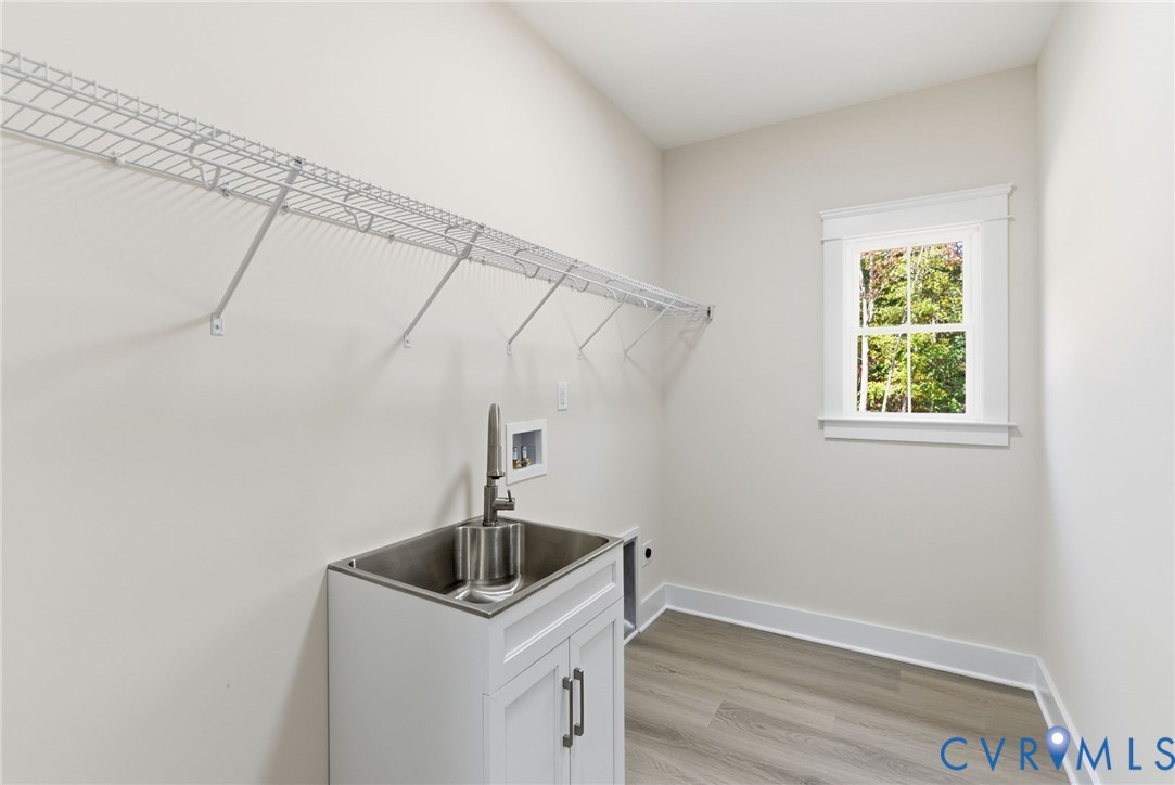 7376 River Road Hanover, VA 23069 - Photo 41 of 46 a bathroom with a sink and washing machine