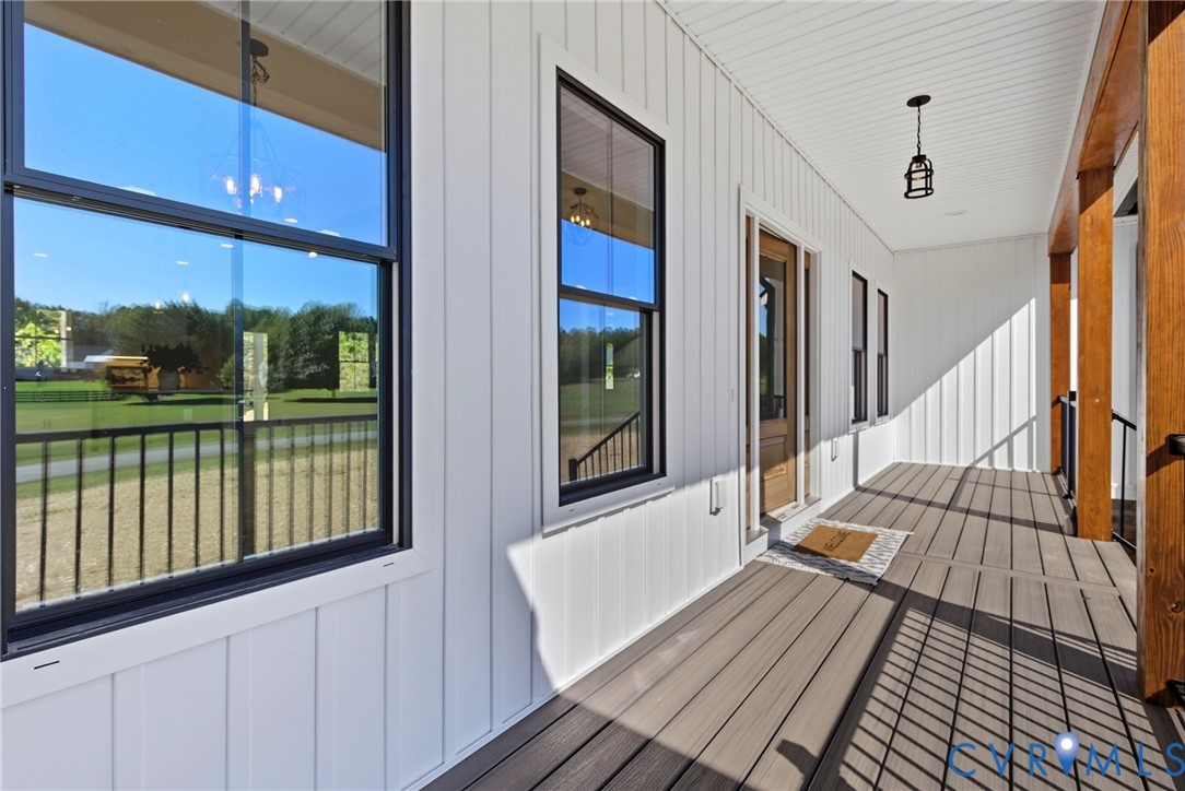 7376 River Road Hanover, VA 23069 - Photo 6 of 46 a view of a balcony with wooden floor and iron stairs