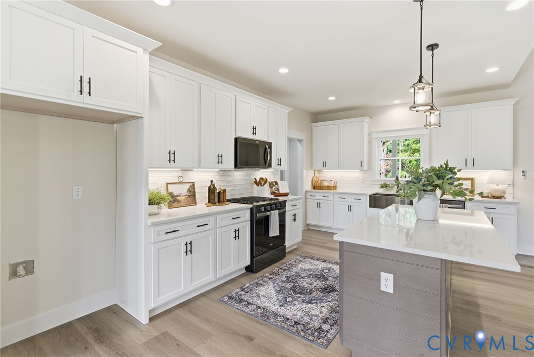 7376 River Road Hanover, VA 23069 - Photo 8 of 46 a kitchen with white cabinets and stainless steel appliances