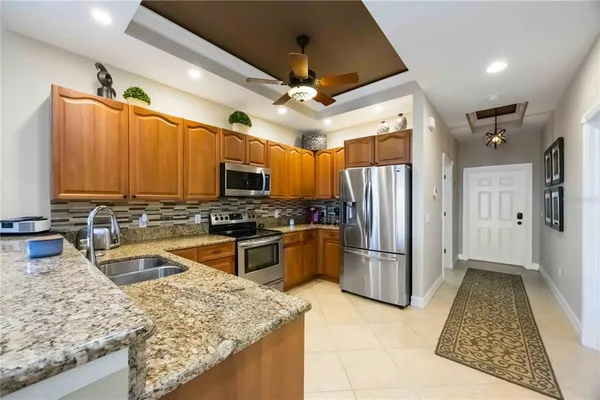a kitchen with stainless steel appliances granite countertop a sink refrigerator and microwave