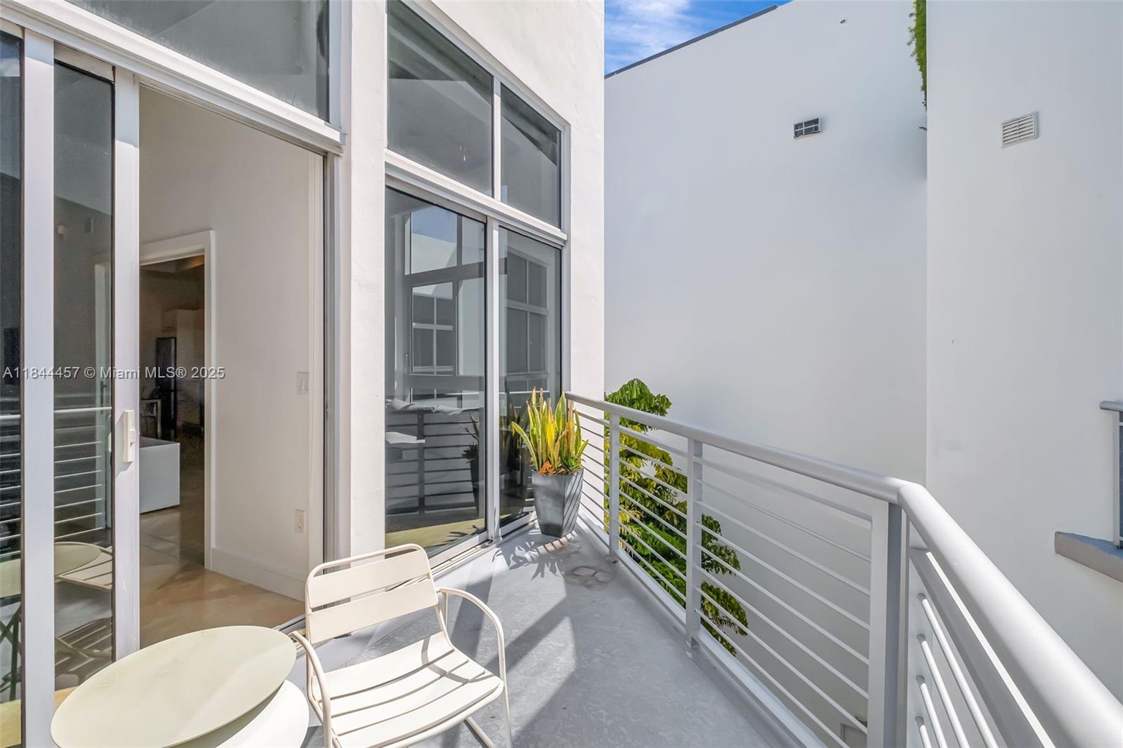 2001 Meridian Avenue, Unit PH15 Miami Beach, FL 33139 - Photo 17 of 31 a floor to ceiling window and wooden floor