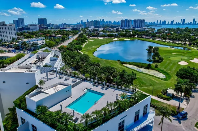 an aerial view of a house with yard swimming pool and outdoor seating