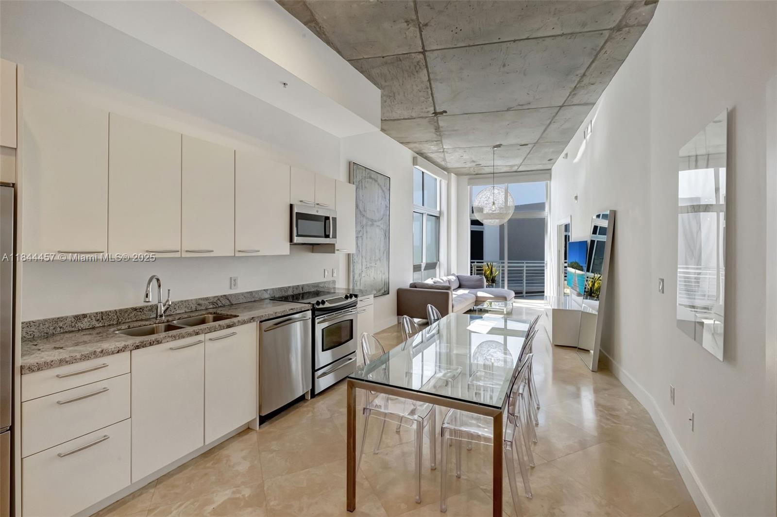 2001 Meridian Avenue, Unit PH15 Miami Beach, FL 33139 - Photo 5 of 31 a kitchen with stainless steel appliances granite countertop a sink a stove counter space and cabinets