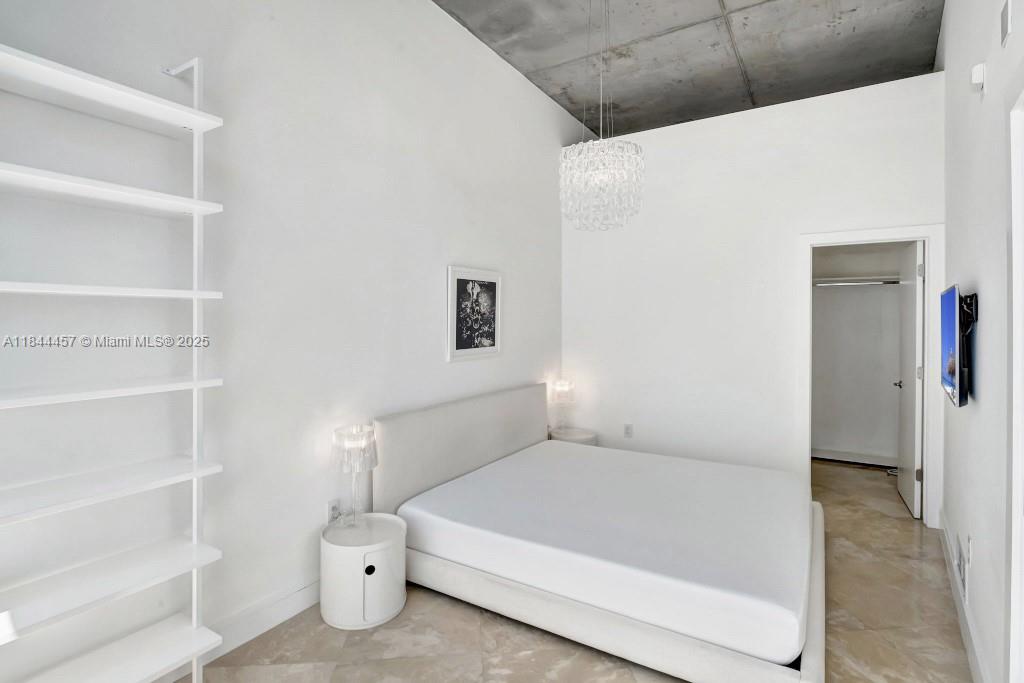 2001 Meridian Avenue, Unit PH15 Miami Beach, FL 33139 - Photo 9 of 31 a spacious bedroom with a bed and a window