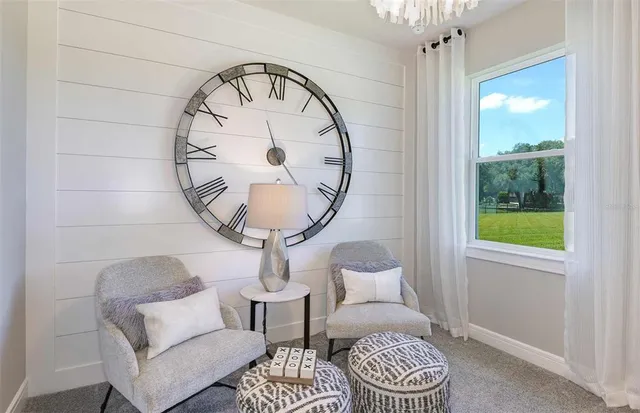 a living room with furniture a table and a large window
