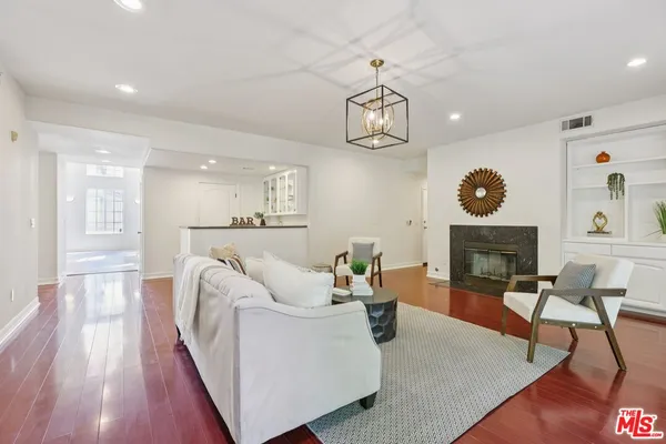 a living room with fireplace furniture and a wooden floor