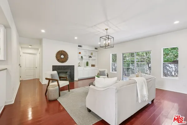 a living room with furniture and a chandelier