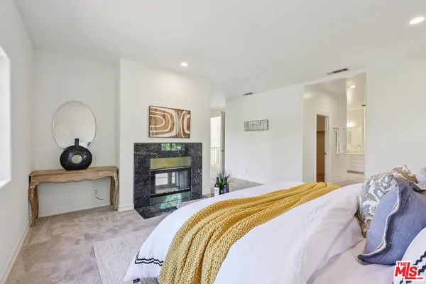 a bedroom with a bed and a fireplace