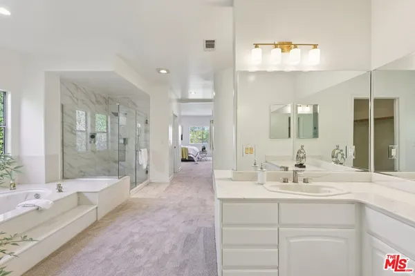 a spacious bathroom with a double vanity sink mirror and double